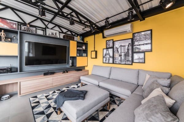 contemporary living room with yellow wall and gray sofa